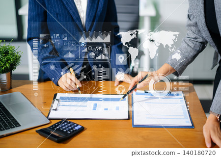 Two businesswomen review financial charts with digital data UI overlays in office. Concept of fintech, big data, global strategy 140180720