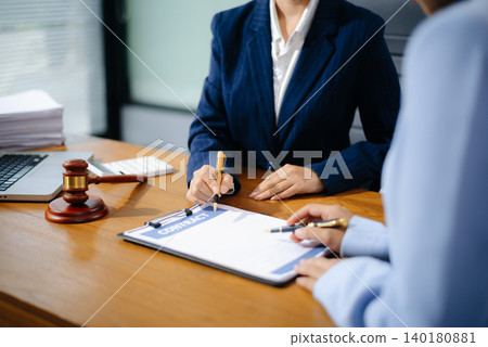 Business and lawyers discussing contract papers with brass scale on desk in office. Law, legal services, advice, justice and law concept Business and lawyers discussing contract papers with brass scale on desk in office. Law, legal services, advice, justice and law concept 140180881