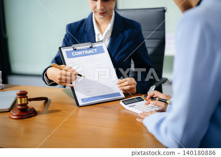 Professional female lawyers consulting on legal cases in a modern office. Perfect for law, business, justice Professional female lawyers consulting on legal cases in a modern office. Perfect for law, business, justice 140180886