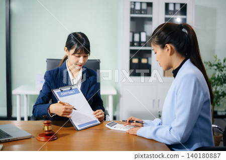 Professional female lawyers consulting on legal cases in a modern office. Perfect for law, business, justice Professional female lawyers consulting on legal cases in a modern office. Perfect for law, business, justice 140180887