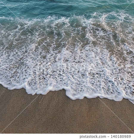 Beautiful emerald green sea and white waves crashing against the sandy beach. Beautiful emerald green sea and white waves crashing against the sandy beach. 140180989