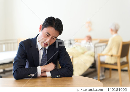 Asian man struggling with caring for his elderly parents 140181003