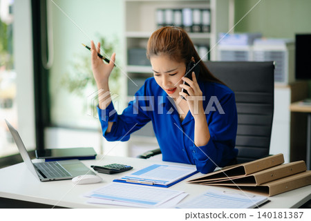 woman feeling migraine head strain.Overworked businesswoman financier while working on laptop and tablet woman feeling migraine head strain.Overworked businesswoman financier while working on laptop and tablet 140181387