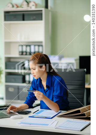 woman feeling migraine head strain.Overworked businesswoman financier while working on laptop and tablet 140181390