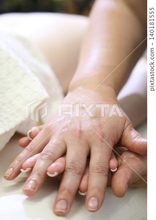 SPA salon and massage. Massage room. A massage therapist is working with a young woman. Hand massage. SPA salon and massage. Massage room. A massage therapist is working with a young woman. Hand massage. 140181555