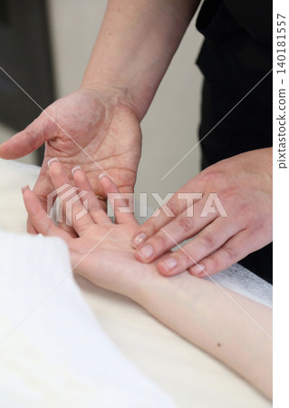 SPA salon and massage. Massage room. A massage therapist is working with a young woman. Hand massage. SPA salon and massage. Massage room. A massage therapist is working with a young woman. Hand massage. 140181557