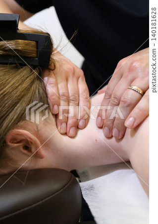 SPA salon and massage. Massage room. A massage therapist is working with a young woman. SPA salon and massage. Massage room. A massage therapist is working with a young woman. 140181628