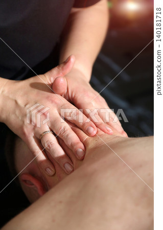 SPA salon. Massage room. A massage therapist is working with a man. Massage parlor. 140181718