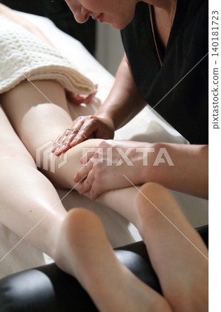 Kyiv, Ukraine - June 2, 2026: SPA salon. Beauty salon and massage. Massage room. A massage therapist is working with a young woman. Hand massage. Kyiv, Ukraine - June 2, 2026: SPA salon. Beauty salon and massage. Massage room. A massage therapist is working with a young woman. Hand massage. 140181723