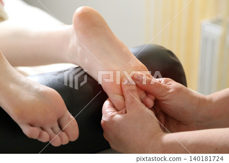 Kyiv, Ukraine - June 2, 2026: SPA salon. Beauty salon and massage. Massage room. A massage therapist is working with a young woman. Hand massage. Kyiv, Ukraine - June 2, 2026: SPA salon. Beauty salon and massage. Massage room. A massage therapist is working with a young woman. Hand massage. 140181724