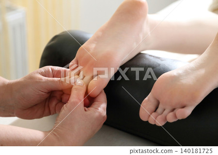 Kyiv, Ukraine - June 2, 2026: SPA salon. Beauty salon and massage. Massage room. A massage therapist is working with a young woman. Hand massage. 140181725