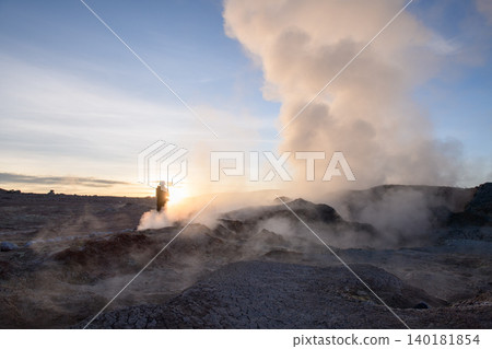 Traveler in awe at Sol de Manana geyser during Bolivia sunrise Traveler in awe at Sol de Manana geyser during Bolivia sunrise 140181854