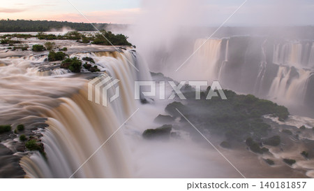 Awe inspiring majestic iguazu falls pouring water with mist in landscape Awe inspiring majestic iguazu falls pouring water with mist in landscape 140181857