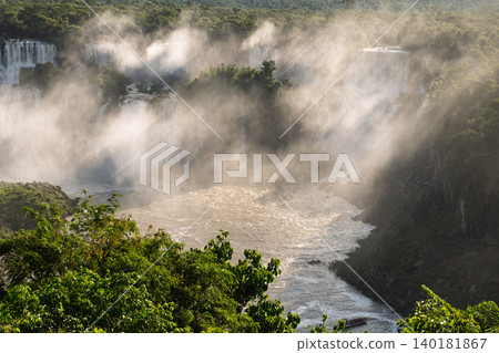 Powerful mist covers dramatic iguazu falls waterfall in wild nature Powerful mist covers dramatic iguazu falls waterfall in wild nature 140181867