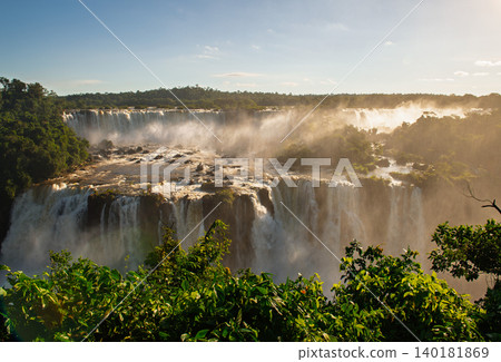 Dramatic and breathtaking iguazu falls landscape showing river dropping into mist Dramatic and breathtaking iguazu falls landscape showing river dropping into mist 140181869