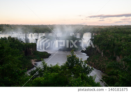 Breathtaking majestic iguazu falls pouring water into river deep inside lush green forest Breathtaking majestic iguazu falls pouring water into river deep inside lush green forest 140181875