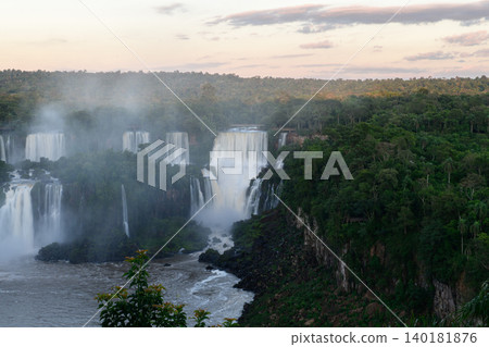 Breathtaking iguazu falls cascading into jungle river creating majestic mist Breathtaking iguazu falls cascading into jungle river creating majestic mist 140181876