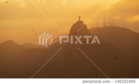 Awe inspiring golden sunset over Christ Redeemer statue and mountains in Rio de Janeiro Brazil feeling peaceful Awe inspiring golden sunset over Christ Redeemer statue and mountains in Rio de Janeiro Brazil feeling peaceful 140181895
