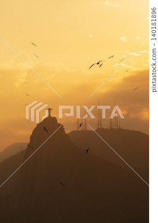 Majestic sunset over Rio de Janeiro Brazil with mountain silhouette of iconic statue creating peaceful feeling Majestic sunset over Rio de Janeiro Brazil with mountain silhouette of iconic statue creating peaceful feeling 140181896