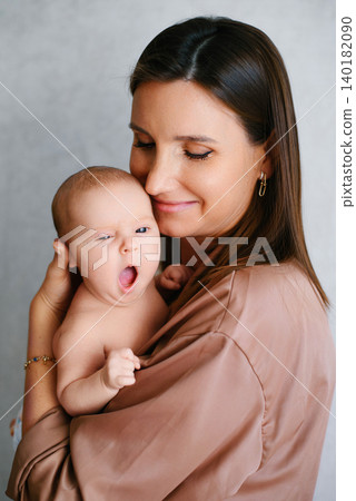 Gentle Mother Holding Yawning Newborn Baby In Arms Gentle Mother Holding Yawning Newborn Baby In Arms 140182090