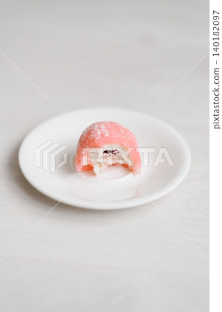 Bitten Pink Mochi Dessert with Cream and Fruit Filling 140182097