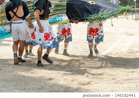 Young people operating the whales on the whale boats during the whale boat festival at Toride Shrine in Yokkaichi City, Mie Prefecture. Young people operating the whales on the whale boats during the whale boat festival at Toride Shrine in Yokkaichi City, Mie Prefecture. 140182441