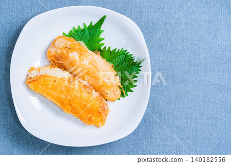 A photo of deep-fried flounder served with shiso leaves. A photo of deep-fried flounder served with shiso leaves. 140182556