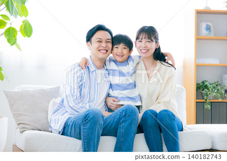 Family portrait of a family sitting on a sofa Family portrait of a family sitting on a sofa 140182743