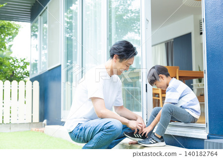 Family: Father and son relaxing in the garden Family: Father and son relaxing in the garden 140182764