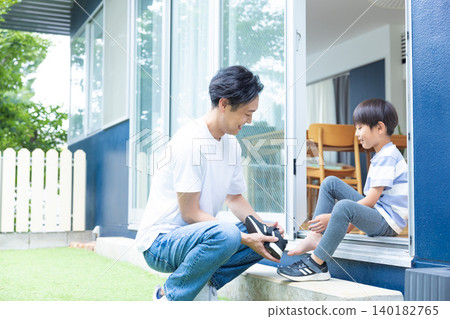 Family: Father and son relaxing in the garden Family: Father and son relaxing in the garden 140182765