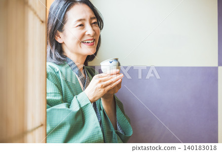 Woman relaxing at the inn 140183018
