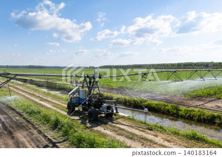Autonomous machine is moving watering pivot along irrigation canal Autonomous machine is moving watering pivot along irrigation canal 140183164