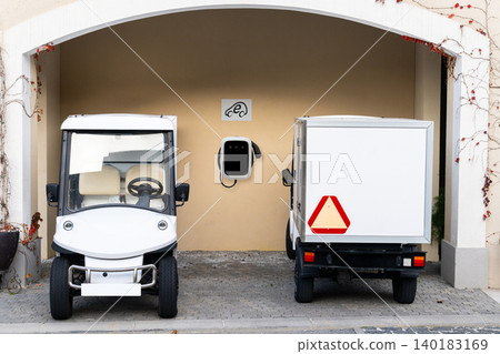 Small urban electric vehicles with charging station 140183169