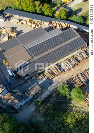 Aerial view of a sawmill factory uses renewable solar energy, with stacks of processed lumber and timber Aerial view of a sawmill factory uses renewable solar energy, with stacks of processed lumber and timber 140183381