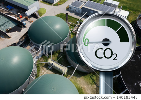 Biogas plant with CO2 emission reduction symbol. Decarbonization and carbon neutrality concept. Biogas plant with CO2 emission reduction symbol. Decarbonization and carbon neutrality concept. 140183443