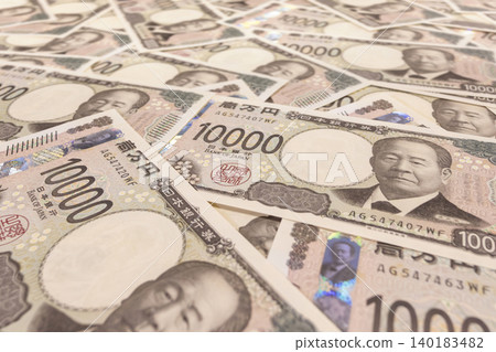 New Japanese banknotes. A photo taken from a low angle showing many 10,000 yen bills lined up. New Japanese banknotes. A photo taken from a low angle showing many 10,000 yen bills lined up. 140183482