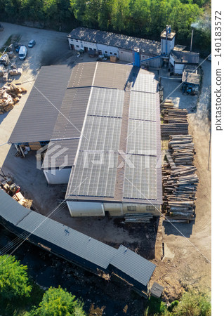 Aerial view of a sawmill factory uses renewable solar energy, with stacks of processed lumber and timber Aerial view of a sawmill factory uses renewable solar energy, with stacks of processed lumber and timber 140183572