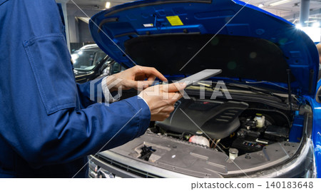 Serviceman with digital tablet on the background of the car in the car service. 140183648