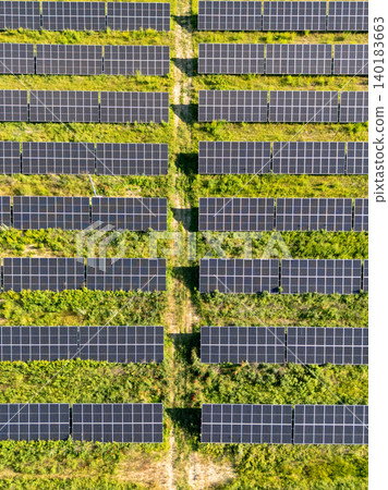 Aerial view of solar power station on a green field. Sustainable development. Aerial view of solar power station on a green field. Sustainable development. 140183663