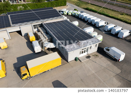 Delivery vans and trucks hub with solar panels on a roof. Fleet of vehicles. 140183797