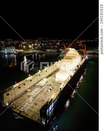 Aerial view of a luxury yacht refit, repair, service and maintenance in a floating dock at night Aerial view of a luxury yacht refit, repair, service and maintenance in a floating dock at night 140183818