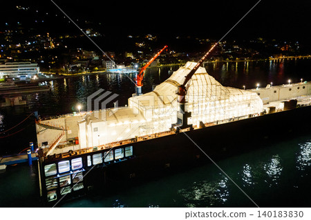 Aerial view of a luxury yacht refit, repair, service and maintenance in a floating dock at night Aerial view of a luxury yacht refit, repair, service and maintenance in a floating dock at night 140183830