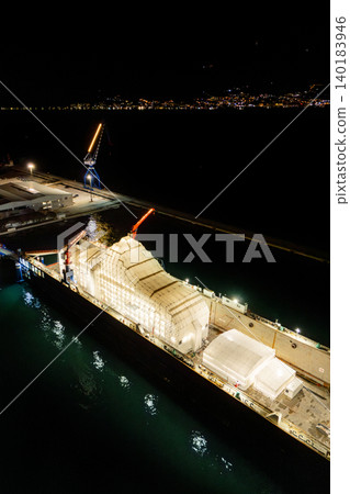 Aerial view of a luxury yacht refit, repair, service and maintenance in a floating dock at night Aerial view of a luxury yacht refit, repair, service and maintenance in a floating dock at night 140183946