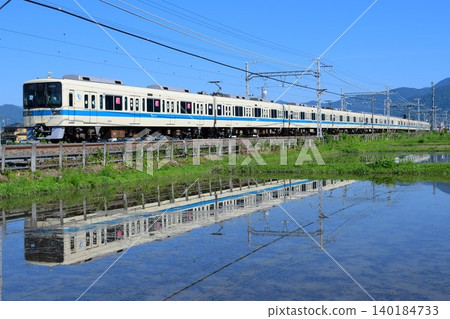 Odakyu 8000 series, train set 8262F, reflected in water. Odakyu 8000 series, train set 8262F, reflected in water. 140184733