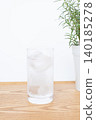 A glass of water and a houseplant 140185278
