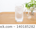 A glass of water and a houseplant 140185282
