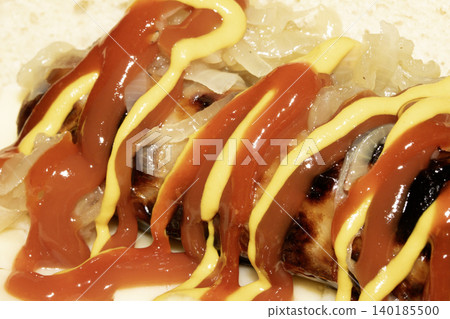 Close up of a hot dog with ketchup and mustard squirted on top dressing Close up of a hot dog with ketchup and mustard squirted on top dressing 140185500