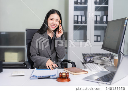 Lawyer office. gavel of Justice with scales and lawyer working on a laptop. Legal law, advice and justice concept. Lawyer office. gavel of Justice with scales and lawyer working on a laptop. Legal law, advice and justice concept. 140185650