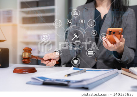 justice and law concept.Female judge in a courtroom the gavel, working with digital smartphone and computer. justice and law concept.Female judge in a courtroom the gavel, working with digital smartphone and computer. 140185653
