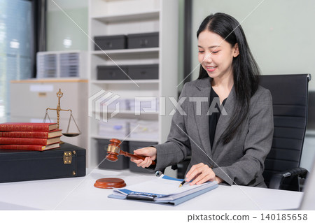 Lawyer office. gavel of Justice with scales and lawyer working on a laptop. Legal law, advice and justice concept. Lawyer office. gavel of Justice with scales and lawyer working on a laptop. Legal law, advice and justice concept. 140185658